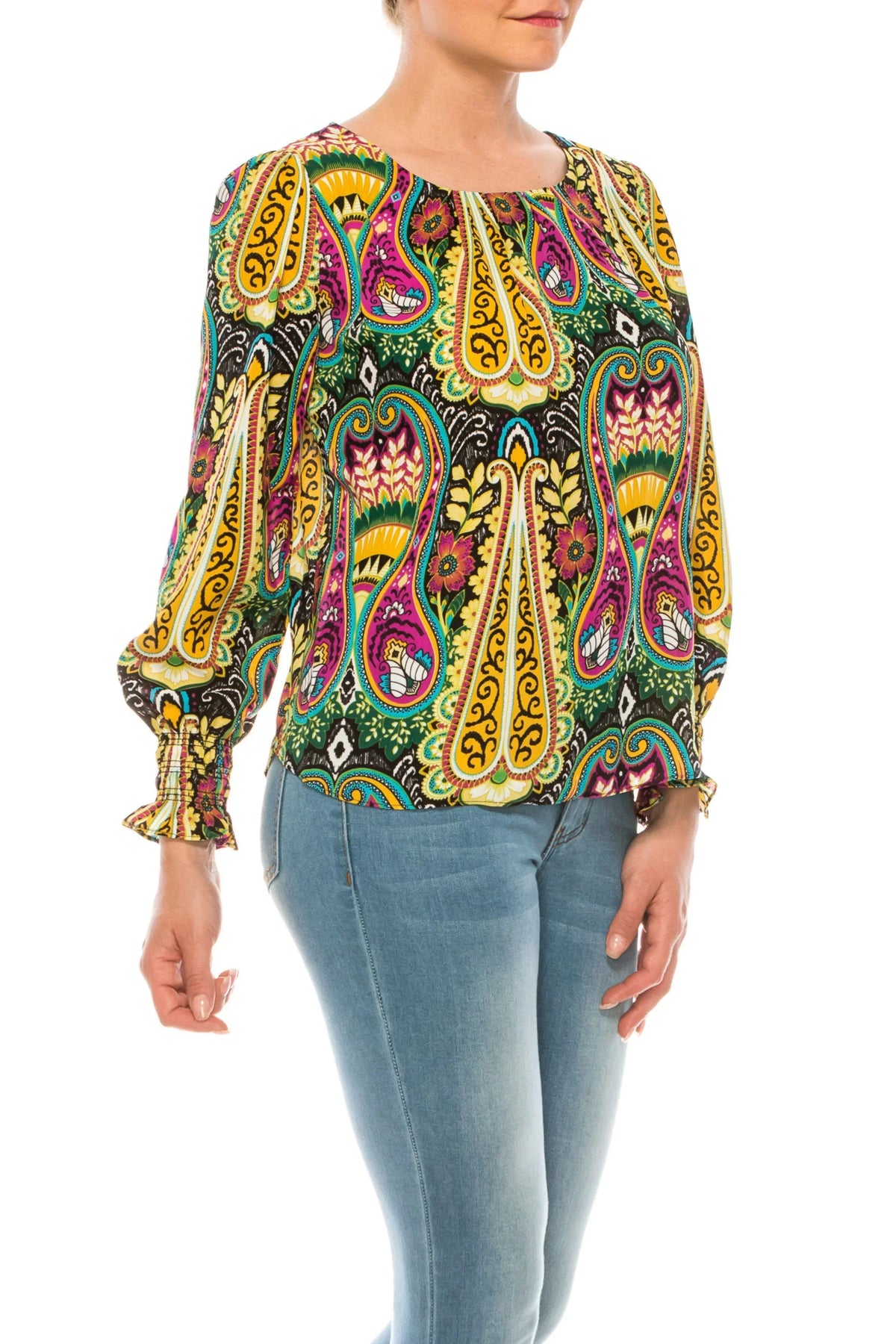 Woman wearing a colorful paisley print long-sleeve blouse and blue skinny jeans