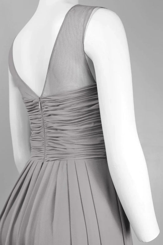 Back view of a women's evening gown with ruched waist and sheer shoulder detailing.