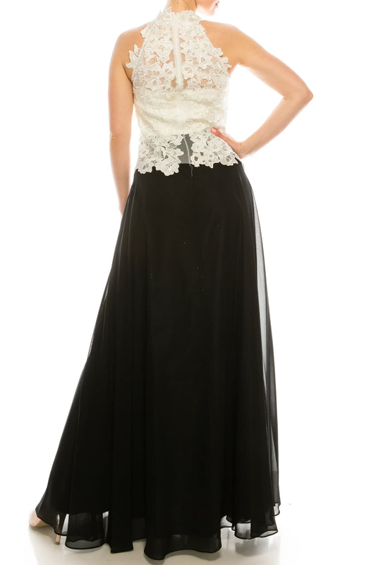 Back view of a woman wearing a white lace bodice and a long black chiffon evening skirt.