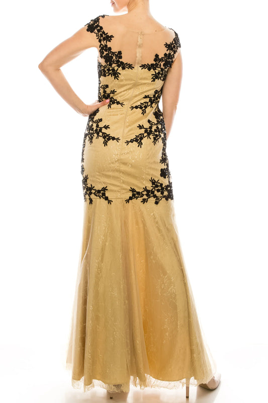 Back view of a gold mermaid evening gown with black floral lace embroidery