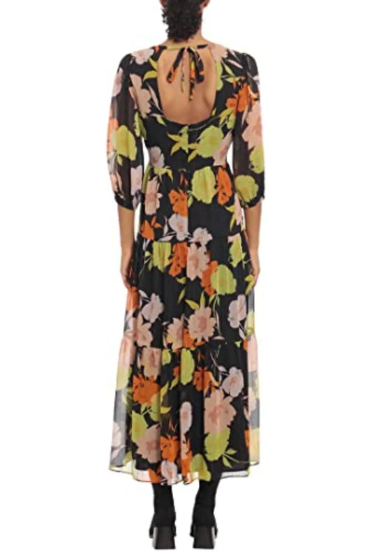 Back view of a woman wearing a black floral print maxi dress with an open back and tie detail.