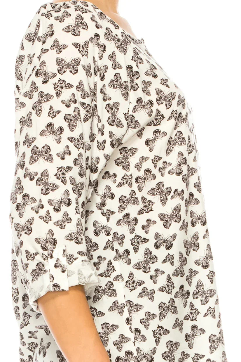 White women's blouse featuring a brown butterfly print and three-quarter length sleeves.