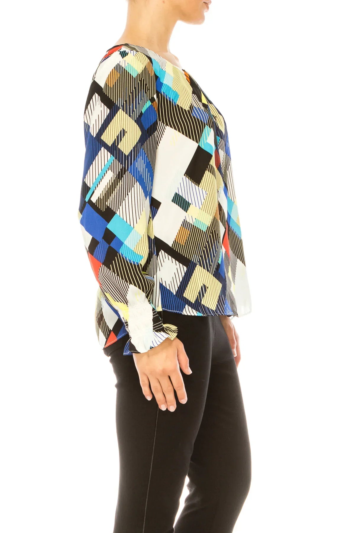 Woman wearing a colorful geometric print blouse with black trousers