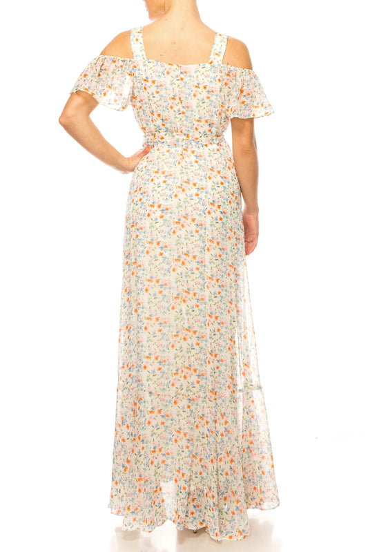 Back view of a woman wearing a white floral print cold-shoulder maxi dress.