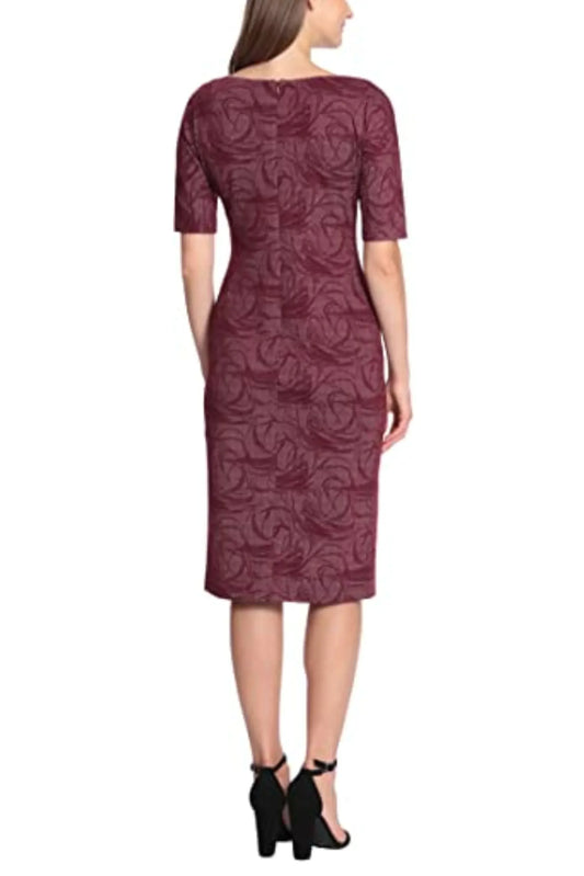 Rear view of a woman wearing a burgundy textured midi sheath dress and black heels.