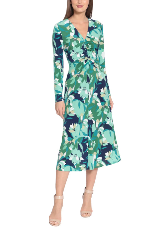 Woman wearing a long-sleeved V-neck midi dress with a teal and white floral print