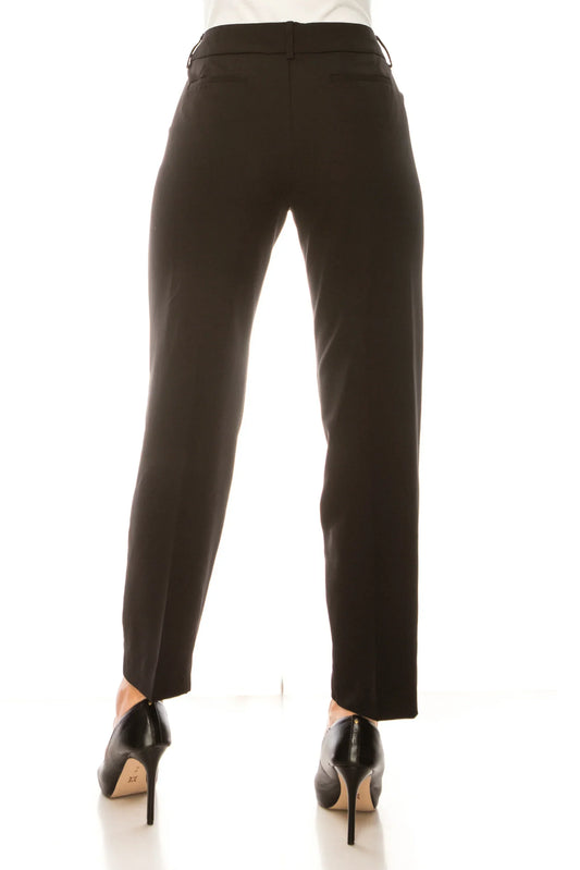 Rear view of a woman wearing tailored black dress pants and high heels.