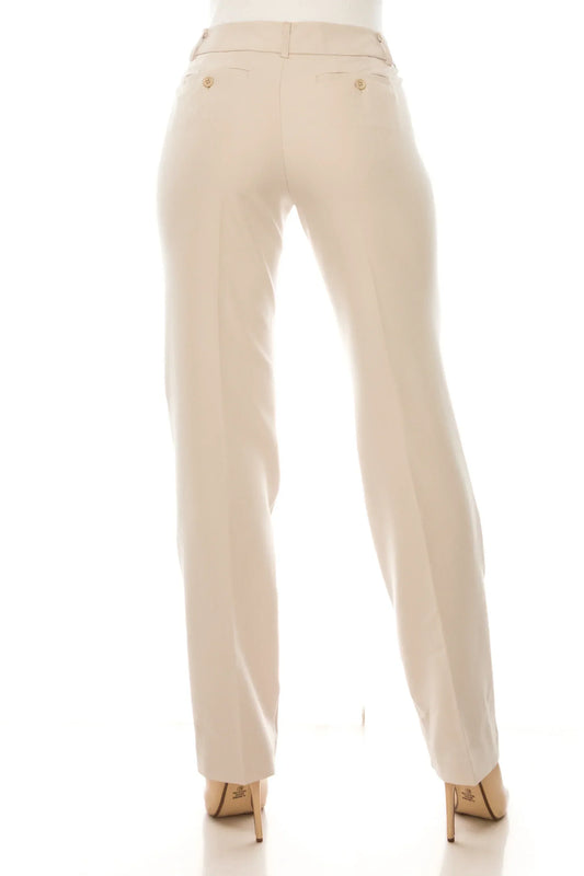 Back view of a woman wearing tailored beige dress pants and nude high heels.