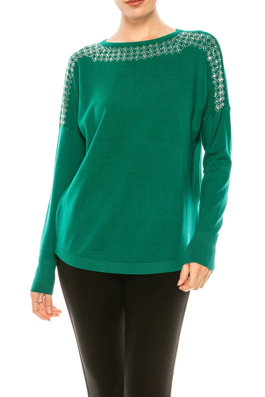 Woman wearing a green long-sleeve sweater with silver sequin neckline and shoulder details.