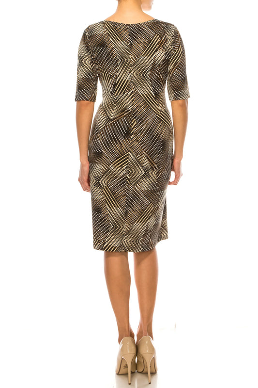 Back view of a woman wearing a geometric print midi dress and beige pumps.