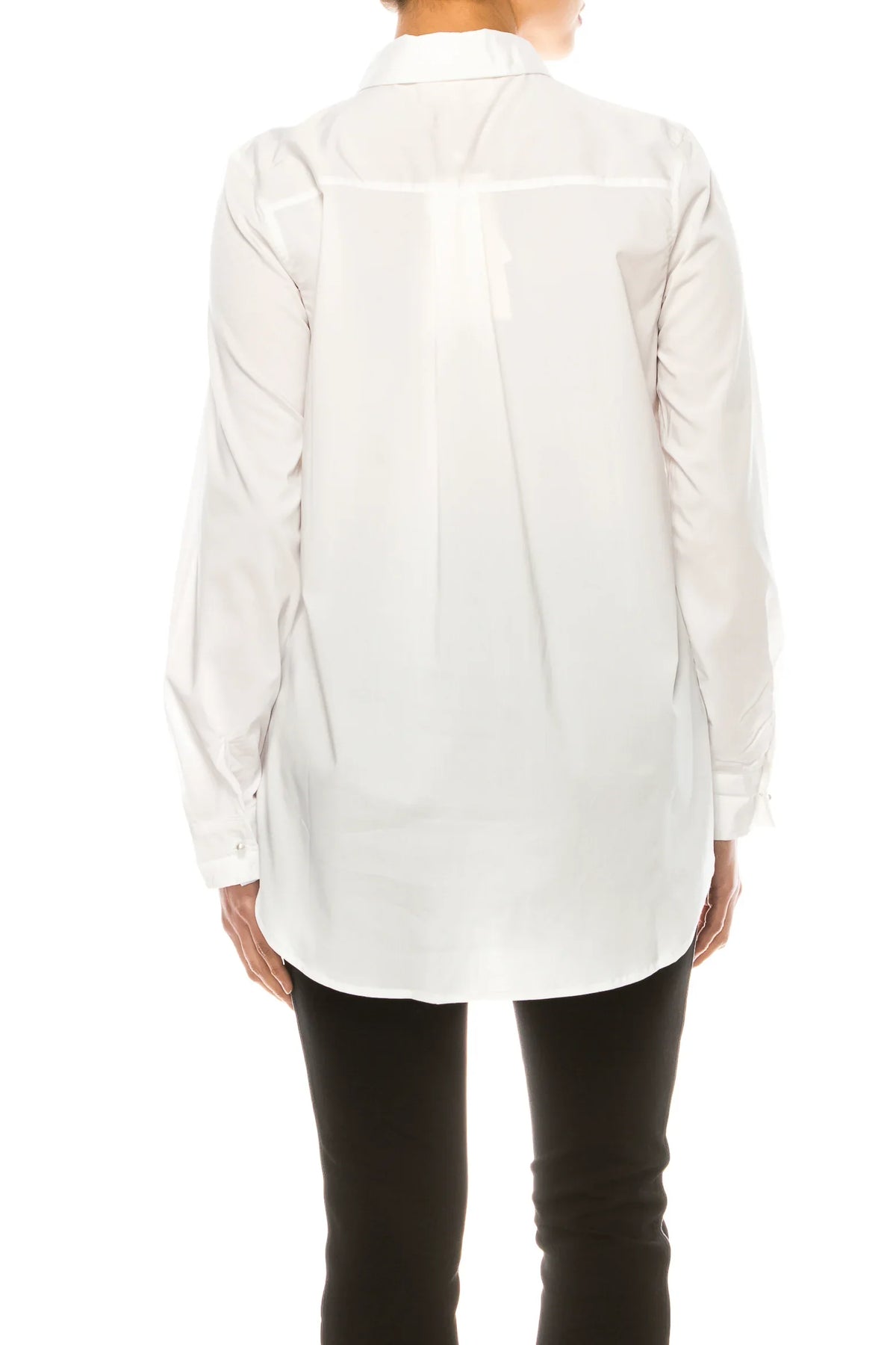 Back view of a woman wearing a long-sleeved white button-down shirt and black trousers.