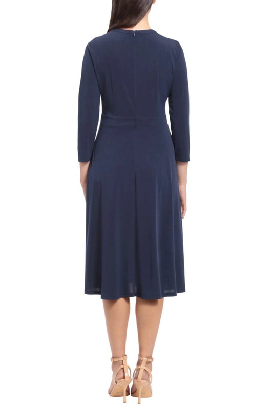 Back view of a woman wearing an elegant navy blue midi dress with three-quarter sleeves.