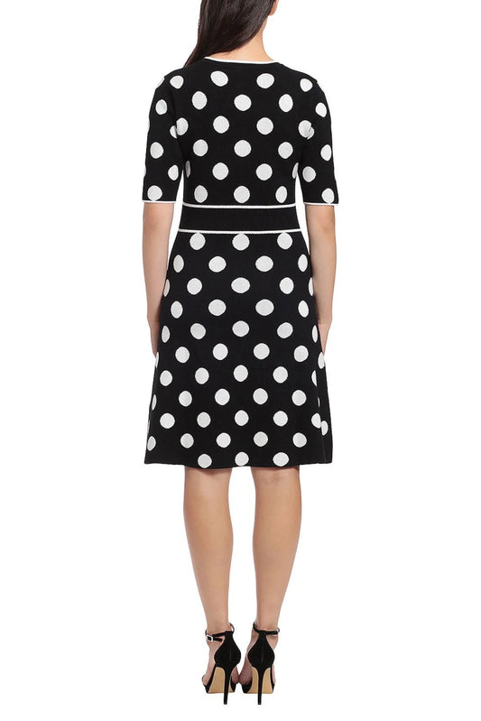 Rear view of a woman wearing a black and white polka dot knit dress and black heels.