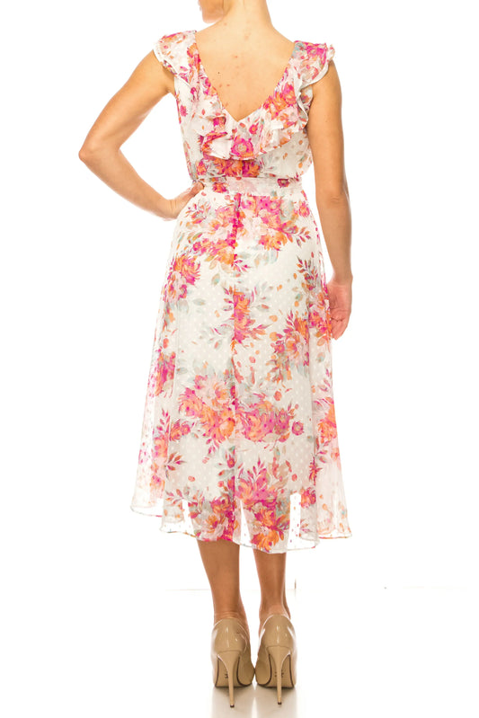 Back view of a woman wearing a floral print midi dress with ruffled shoulders and nude heels