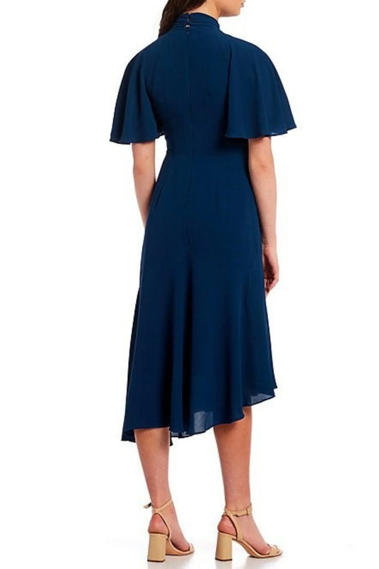 Back view of Maggy London dark denim blue mock neck midi dress with flutter sleeves.