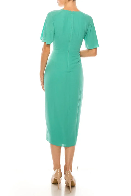 Back view of a Maggy London green short sleeve midi dress on a model.