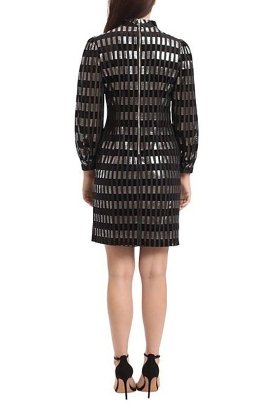 Back view of a woman wearing a black and silver metallic striped long-sleeve dress