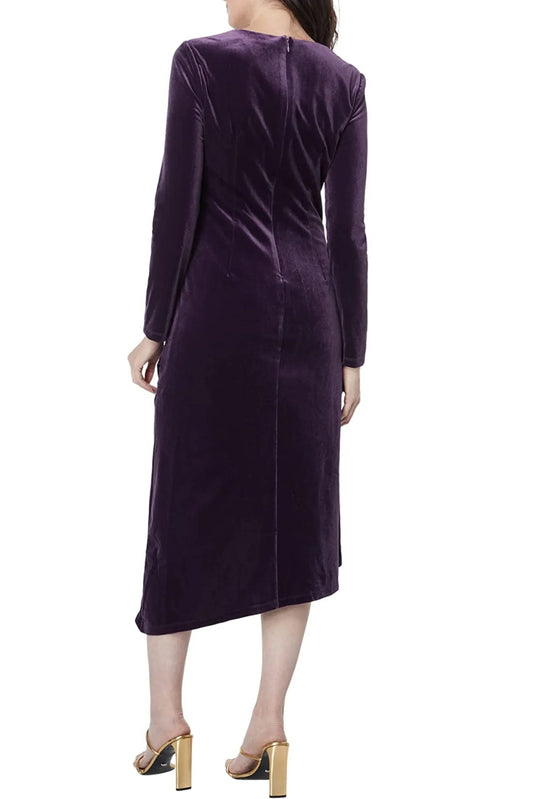 Back view of a woman wearing an elegant purple velvet long-sleeve midi dress and gold heels.