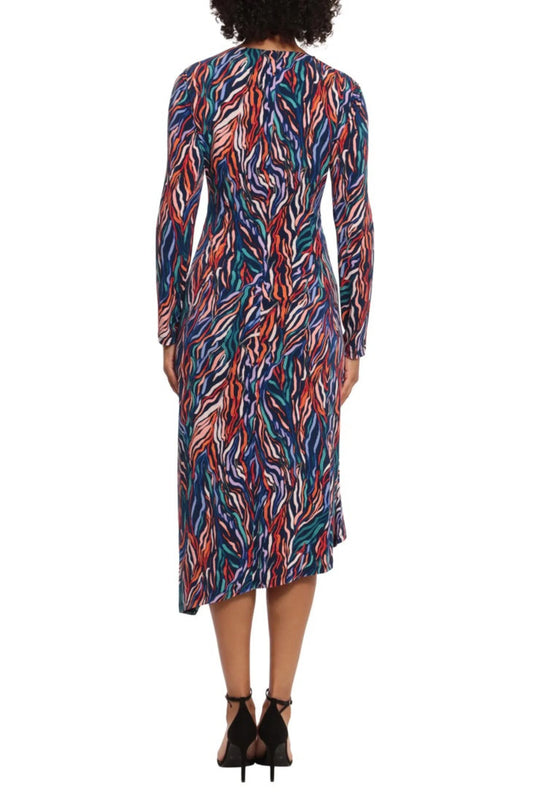 Rear view of a woman wearing a colorful multi-colored abstract print midi dress with long sleeves.