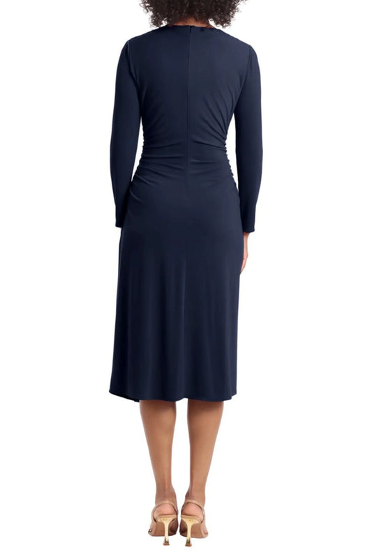 Back view of a woman wearing an elegant navy blue long-sleeve midi dress and gold heels.
