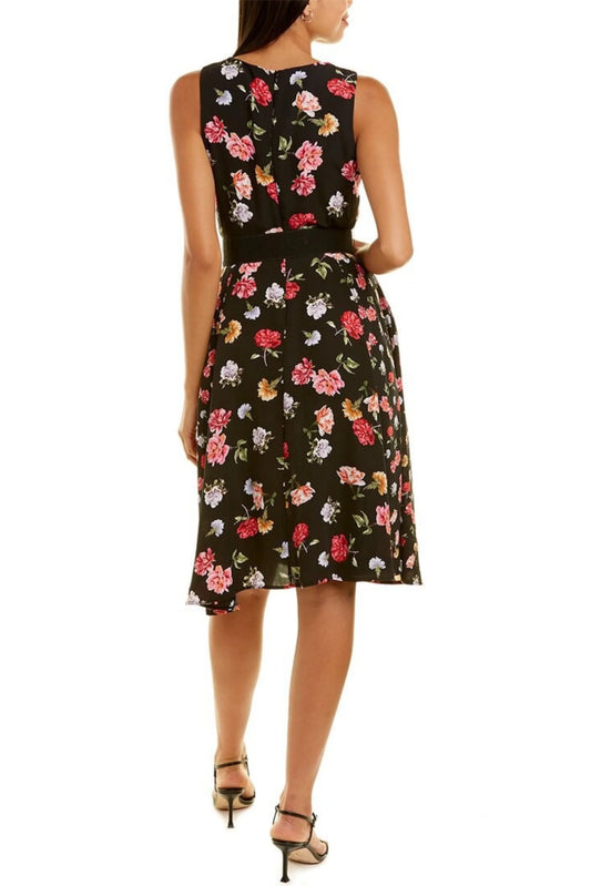 Back view of a woman wearing a black sleeveless midi dress with a colorful floral print