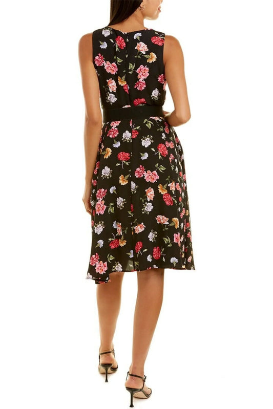 Back view of a woman wearing a black sleeveless midi dress with a colorful floral print
