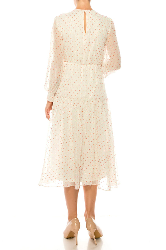 Back view of Maison Tara white dot texture print tiered maxi dress with long sleeves.
