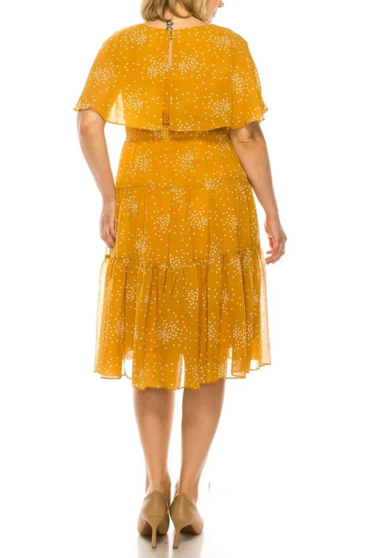 Back view of Maison Tara yellow dot print cape tiered A-line midi dress.
