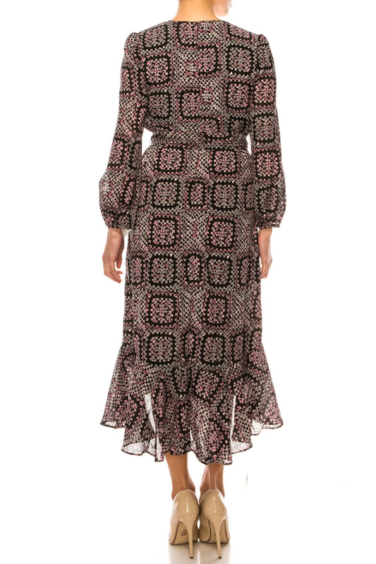 Back view of a woman wearing a printed midi dress with a ruffled hem and beige heels.