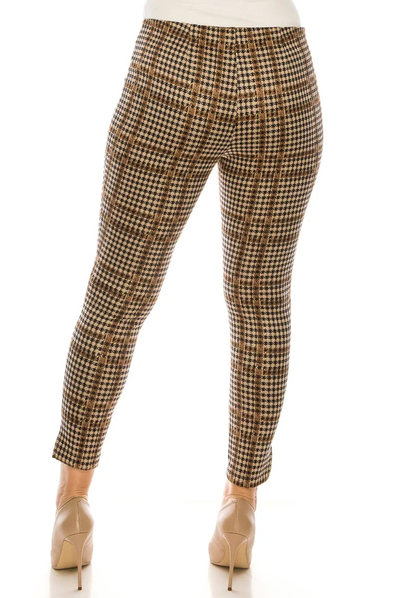 Woman wearing brown and tan houndstooth patterned slim-fit trousers and beige heels.