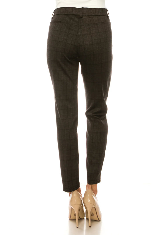 Rear view of a woman wearing dark grey plaid slim-fit trousers and beige high heels.