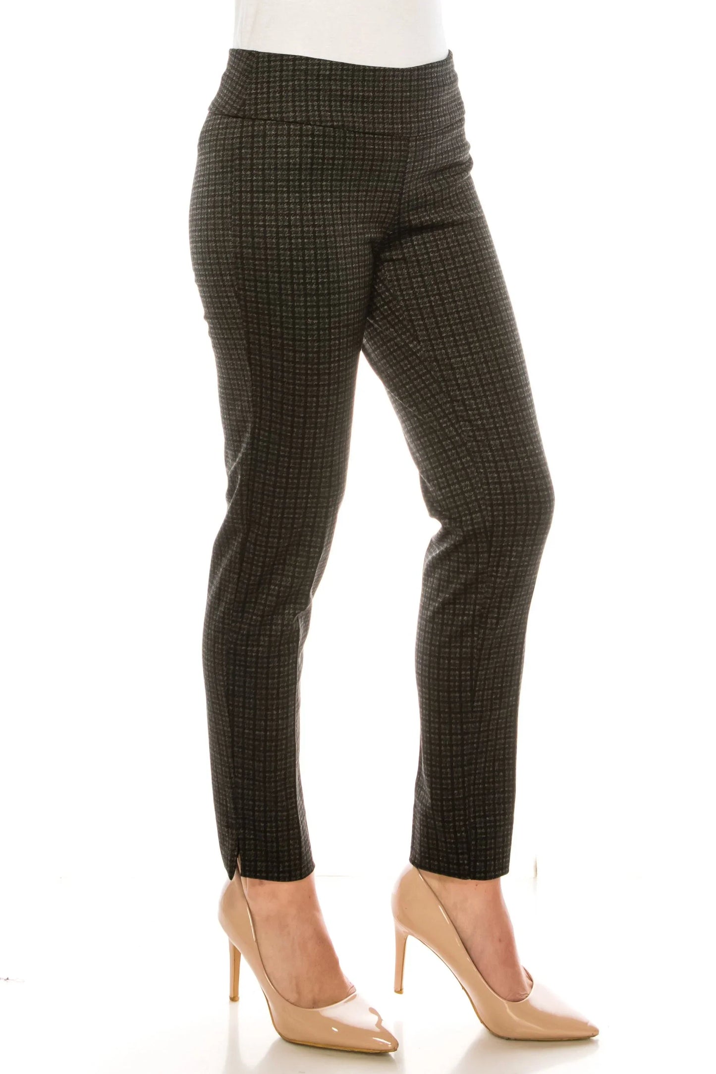 Woman wearing dark grey textured slim-fit trousers and nude pointed-toe heels.
