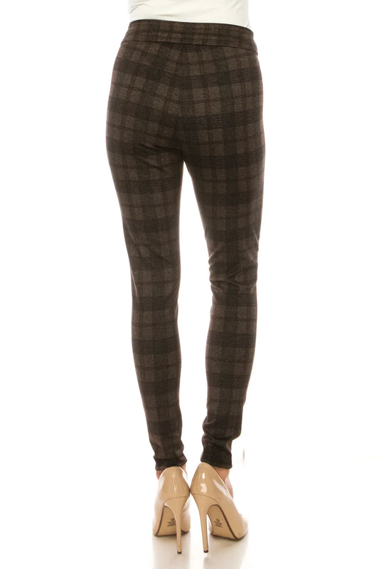 Back view of a woman wearing brown plaid leggings and nude high heels.