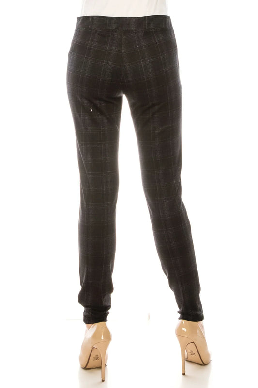 Back view of a woman wearing slim-fit charcoal grey plaid trousers and nude heels.