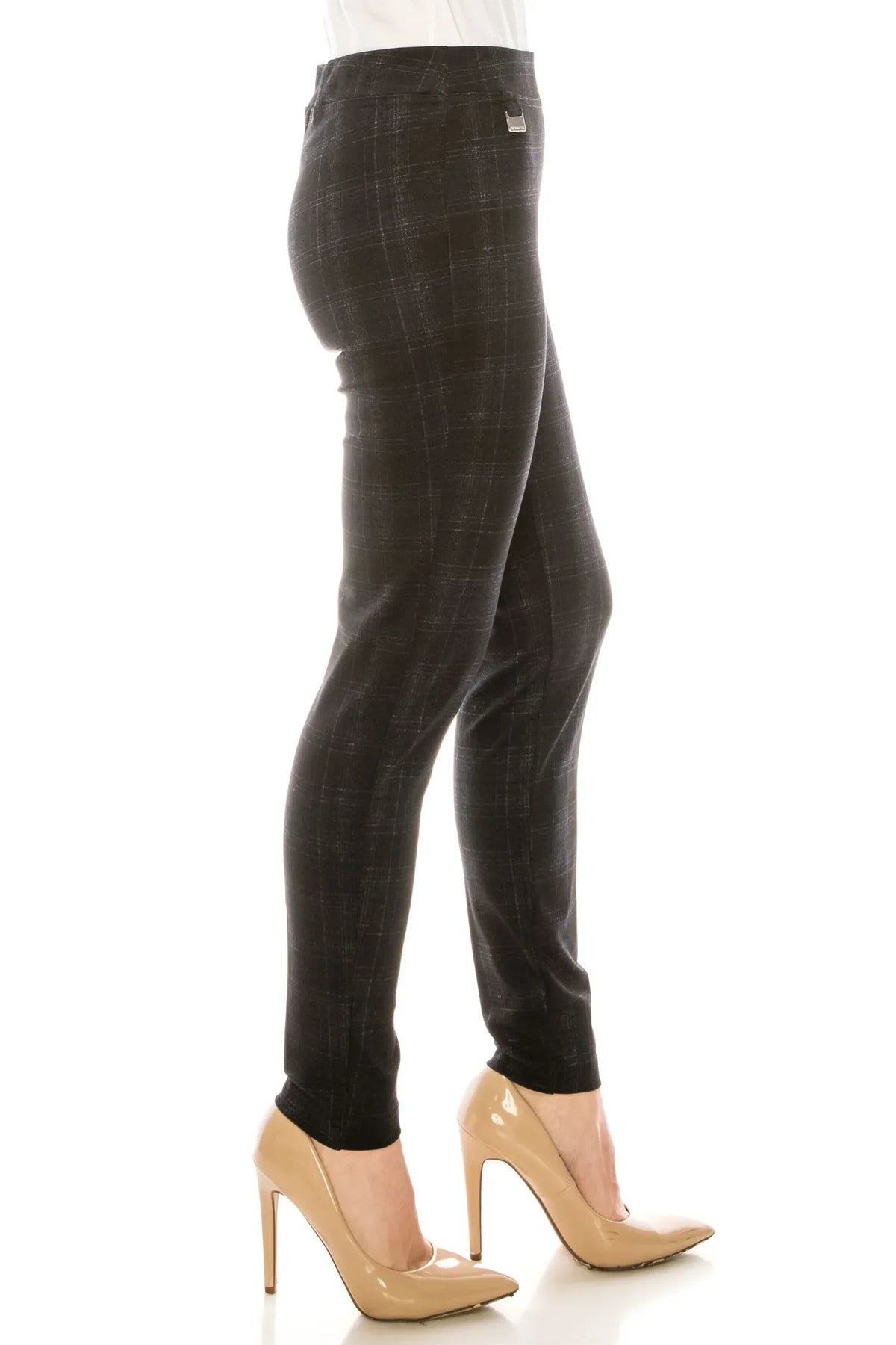 Side view of a woman wearing charcoal grey plaid slim-fit trousers and beige high heels.