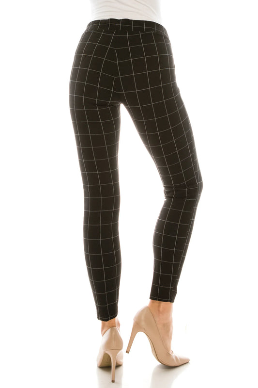 Back view of a woman wearing black grid-patterned leggings and nude high-heel pumps.