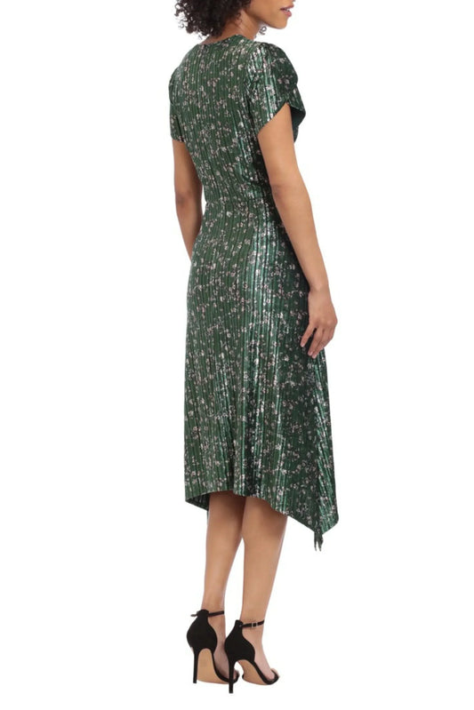 Woman wearing a green pleated floral midi dress and black heels, back view.